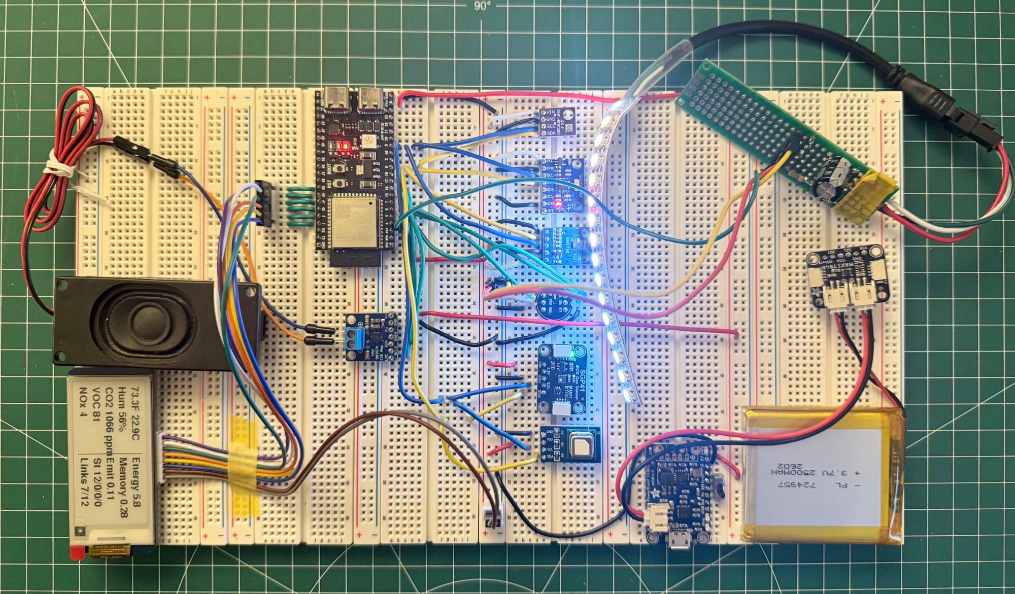 Creature v07.0 hardware on a breadboard: the ESP32, sensors, LED strip, speaker, battery and the e-paper readout